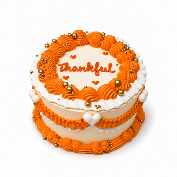 Thankful Thanksgiving cake with orange-and-ivory piping, gold pearls and heart details by The Place Toronto